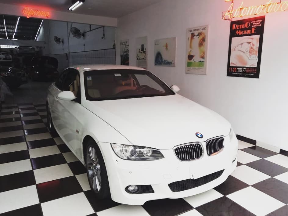 Carro BMW branco em oficina